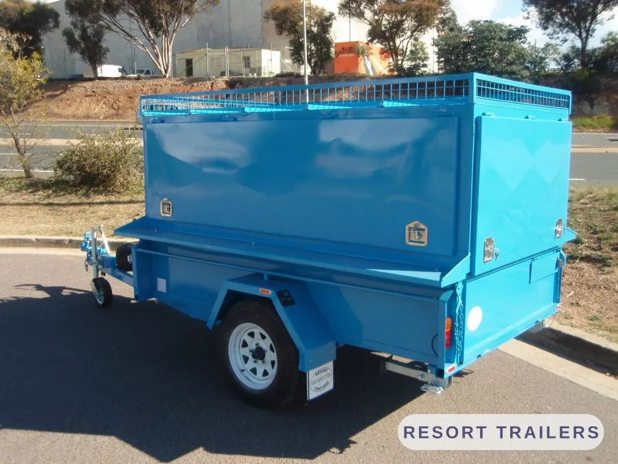 Blue BBQ trailer closed up for towing — built by Resort Trailers