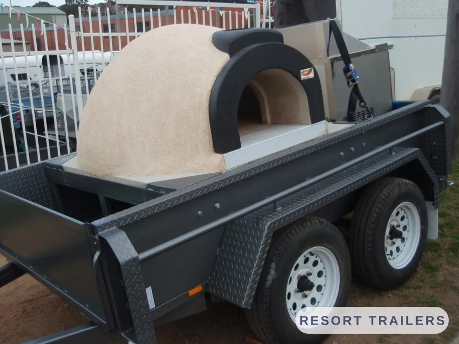 Wood-fired pizza oven mounted on a tandem trailer — built by Resort Trailers