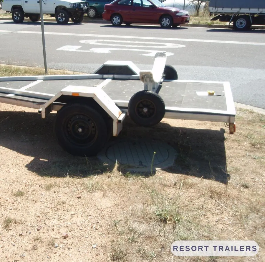 Alloy boat trailer with carpeted bunks and a swing-up winch post — built by Resort Trailers