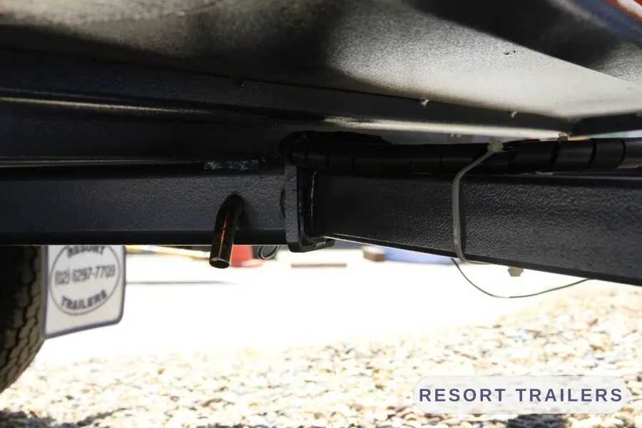 Overhead rack carrying a kayak above the toolbox — built by Resort Trailers