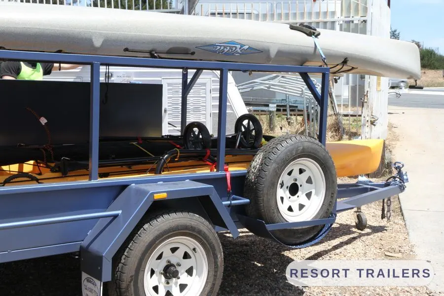 Spare wheel mounted on the drawbar side of the kayak trailer — built by Resort Trailers