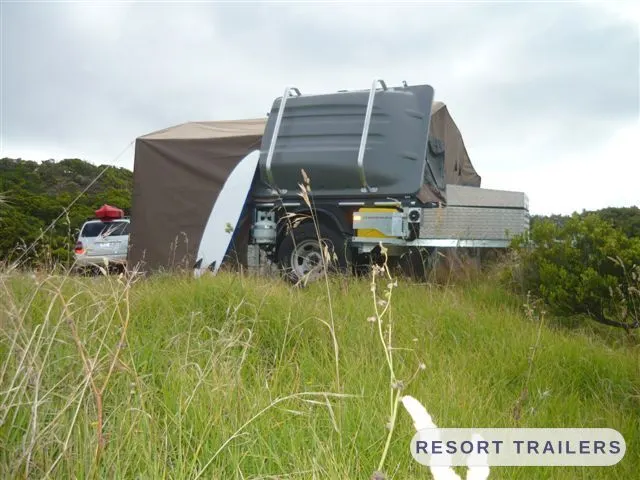 Camper trailer set up alongside the tow vehicle — built by Resort Trailers