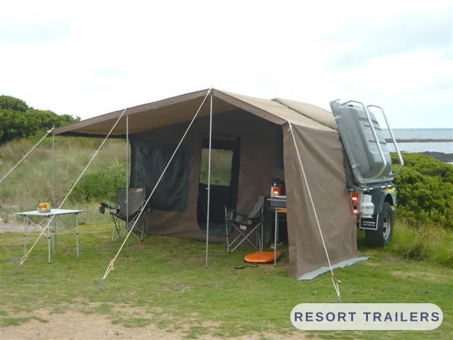 Camper trailer with the full annexe up at a coastal campsite — built by Resort Trailers