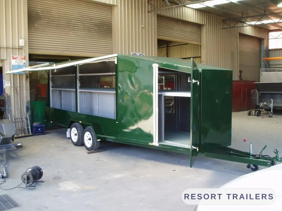 Long enclosed trailer with serving hatch and side doors — built by Resort Trailers