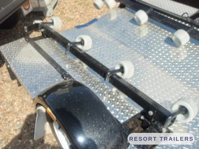 Roller bunks over the checker-plate deck — built by Resort Trailers