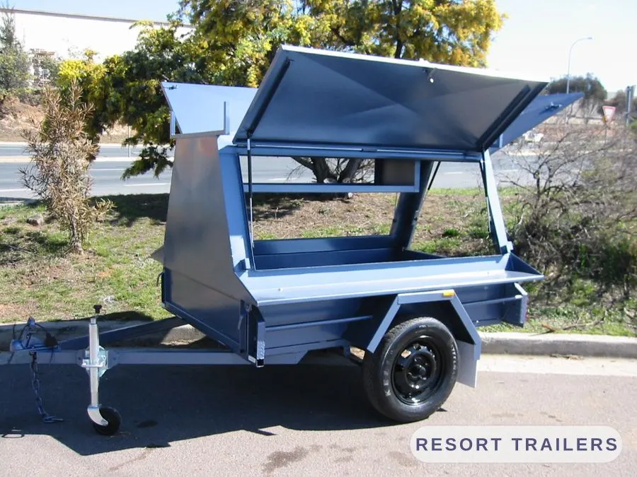 Canopy trailer with one gull-wing lid raised — built by Resort Trailers