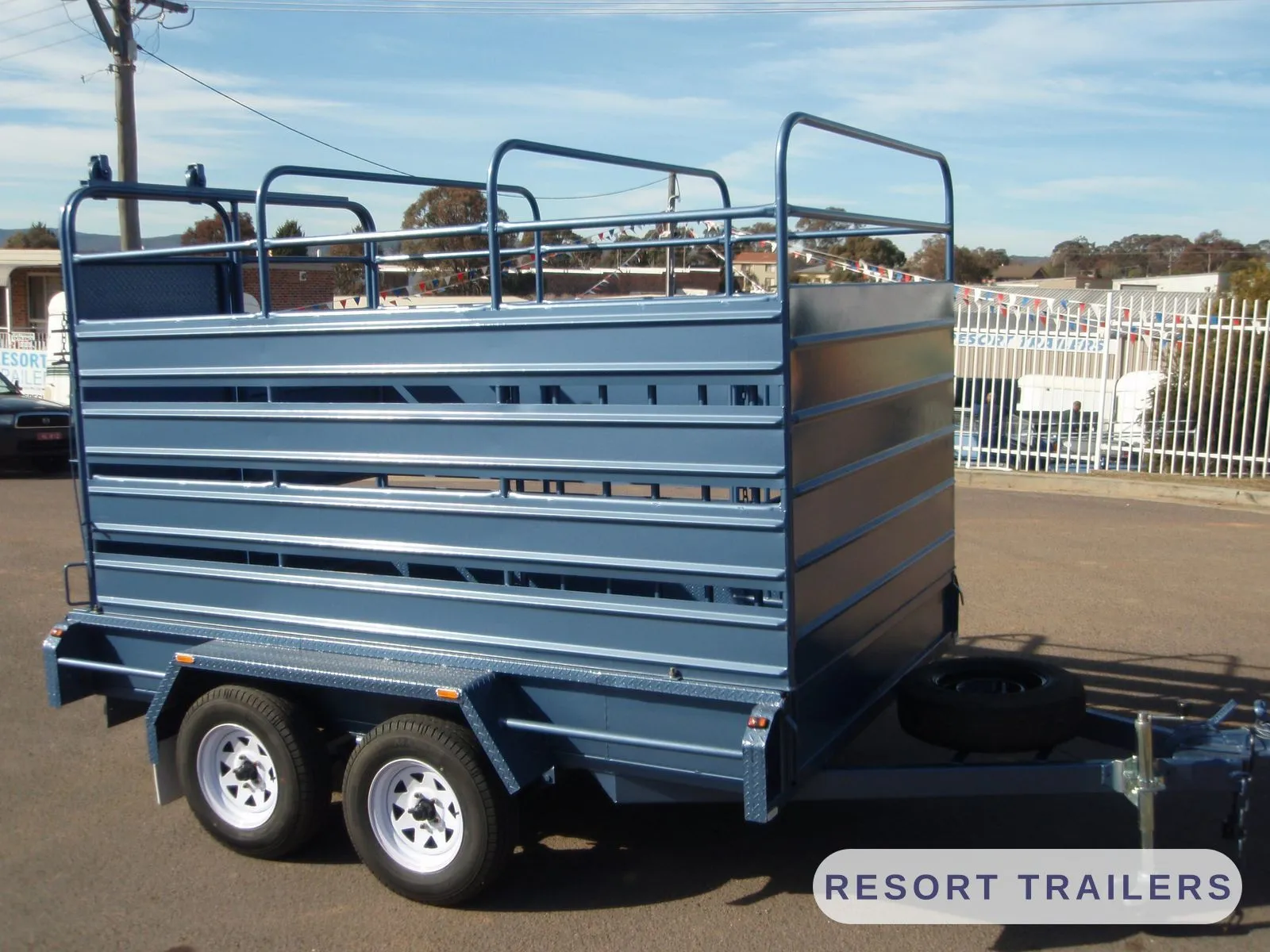 Tandem stock crate with full-height rails — built by Resort Trailers