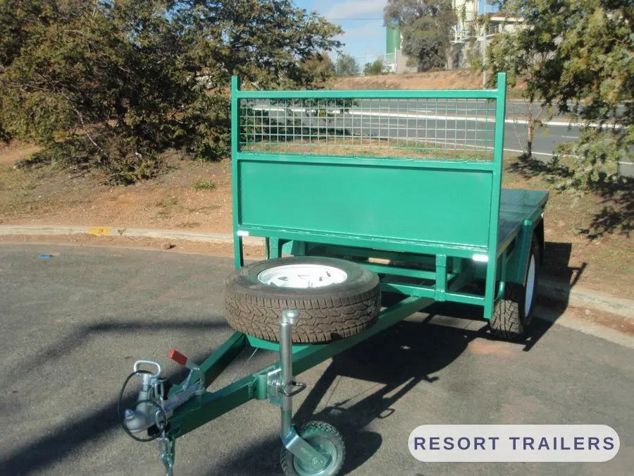 Green table top with a cage headboard and spare wheel — built by Resort Trailers