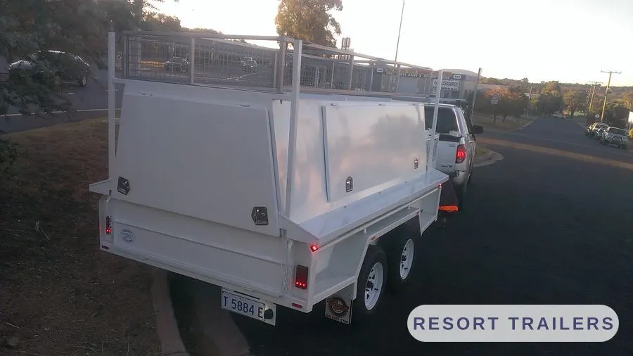 Tri-axle trade trailer with canopy and ladder rack — built by Resort Trailers