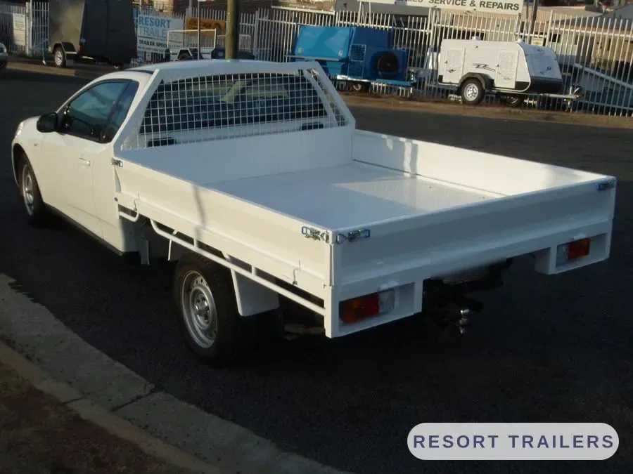 Steel tray with a mesh headboard, rear three-quarter — built by Resort Trailers